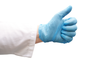 Hand in medizinischen Handschuh, mit Daumen nach oben